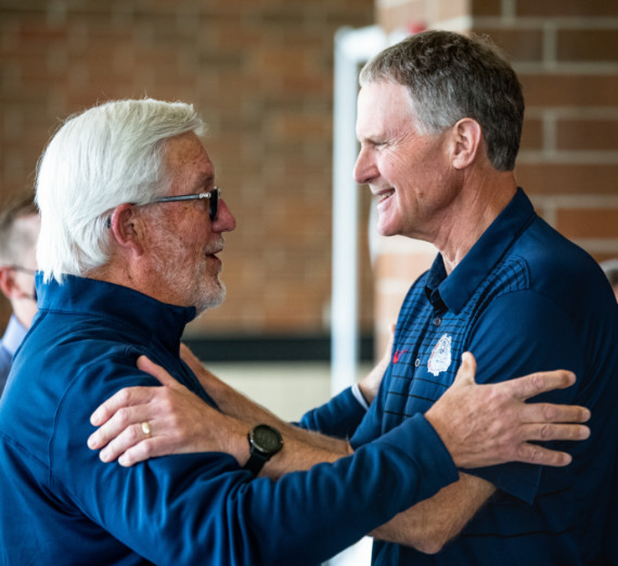 Gonzaga’s 1950 boxing champions are welcomed home under a banner celebrating their national title.
